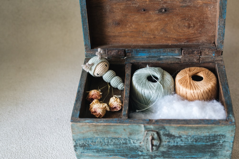 two skeins of yarn in a wooden box