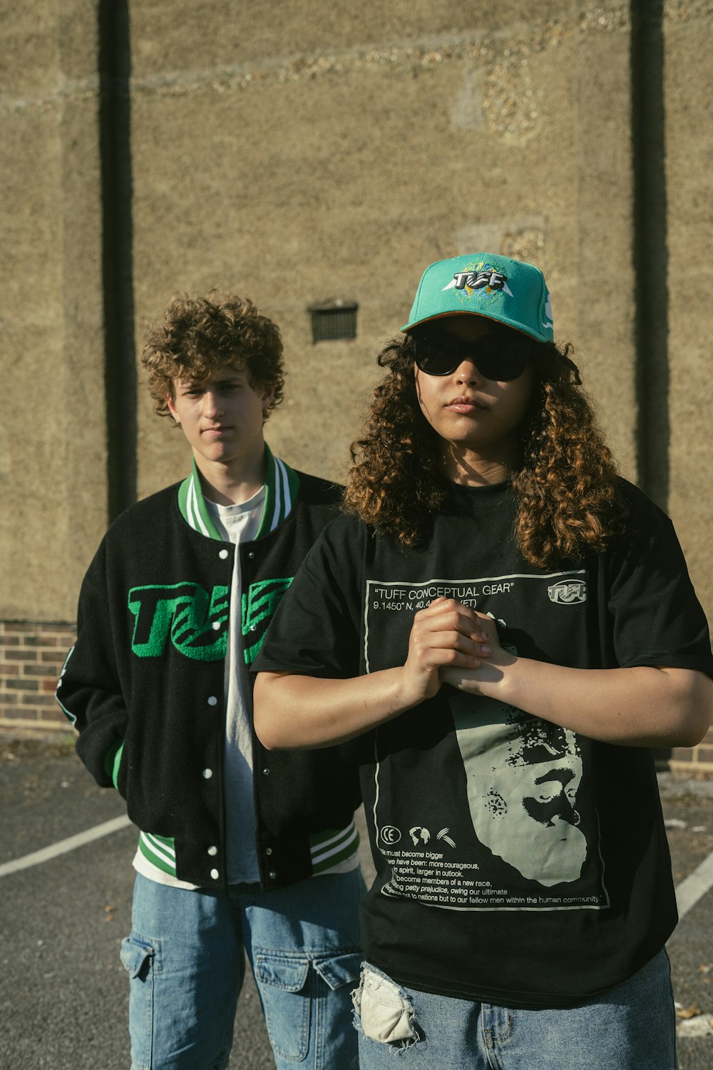 a couple of young men standing next to each other