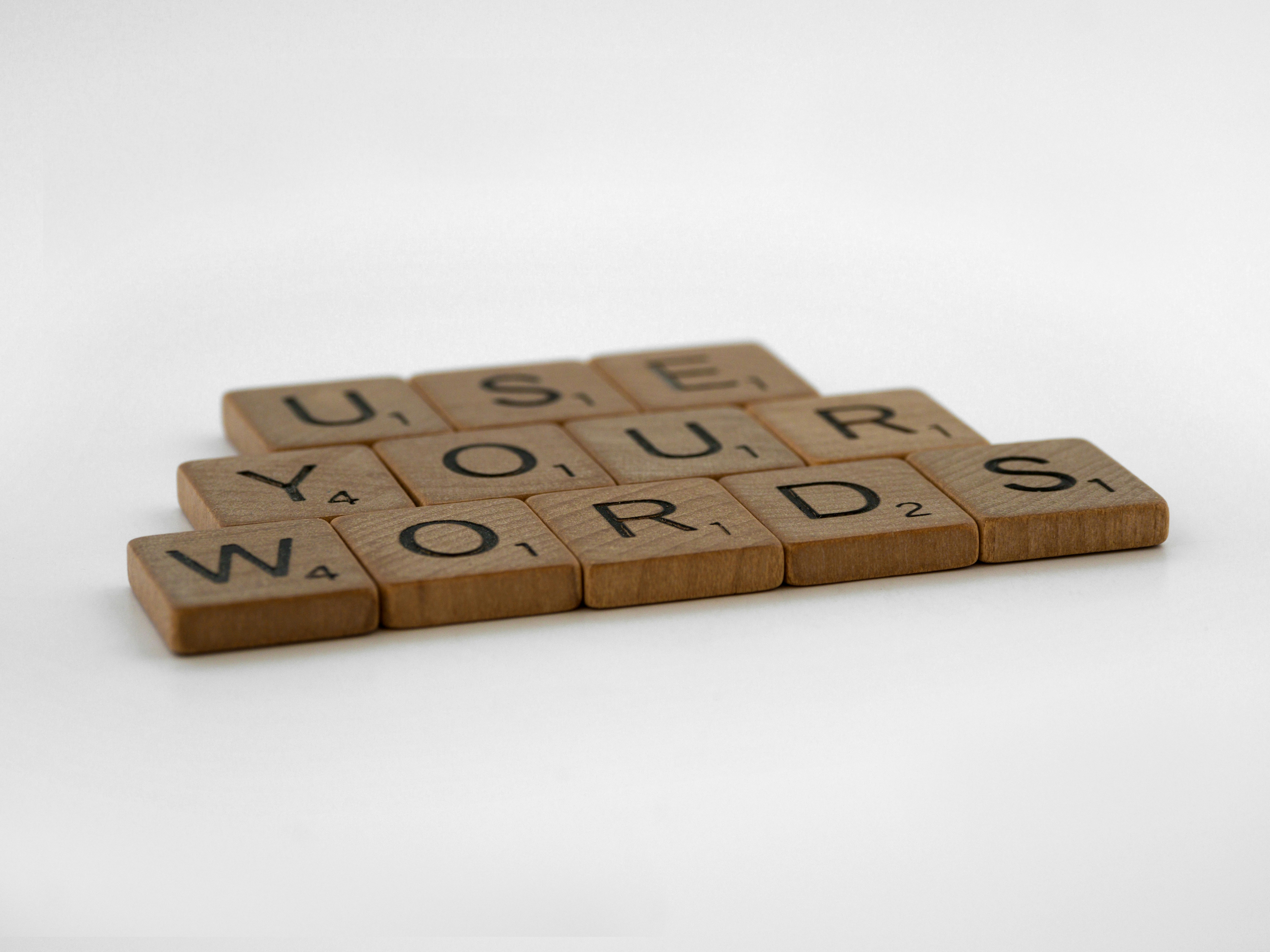 a scrabbled wooden block that says use your words