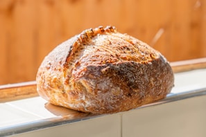 A rustic bread loaf with a crispy crust, freshly baked.
