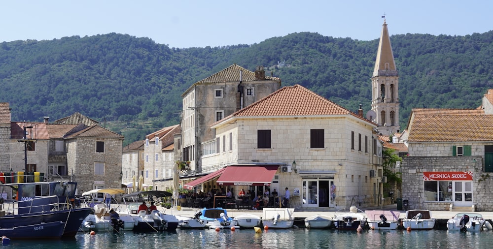 a group of boats docked in a harbor next to buildings