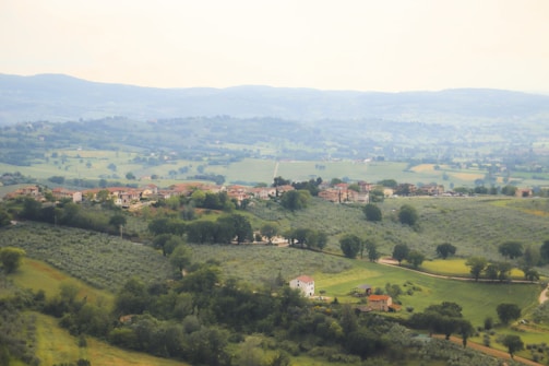 A peaceful Indian countryside with rolling hills and traditional homes.