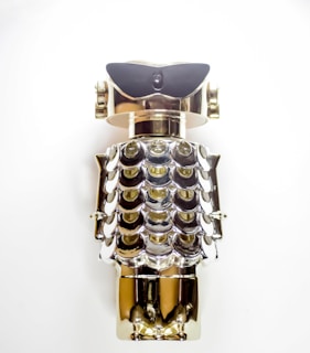 Shiny robot collectibles reflecting light on a glossy black base