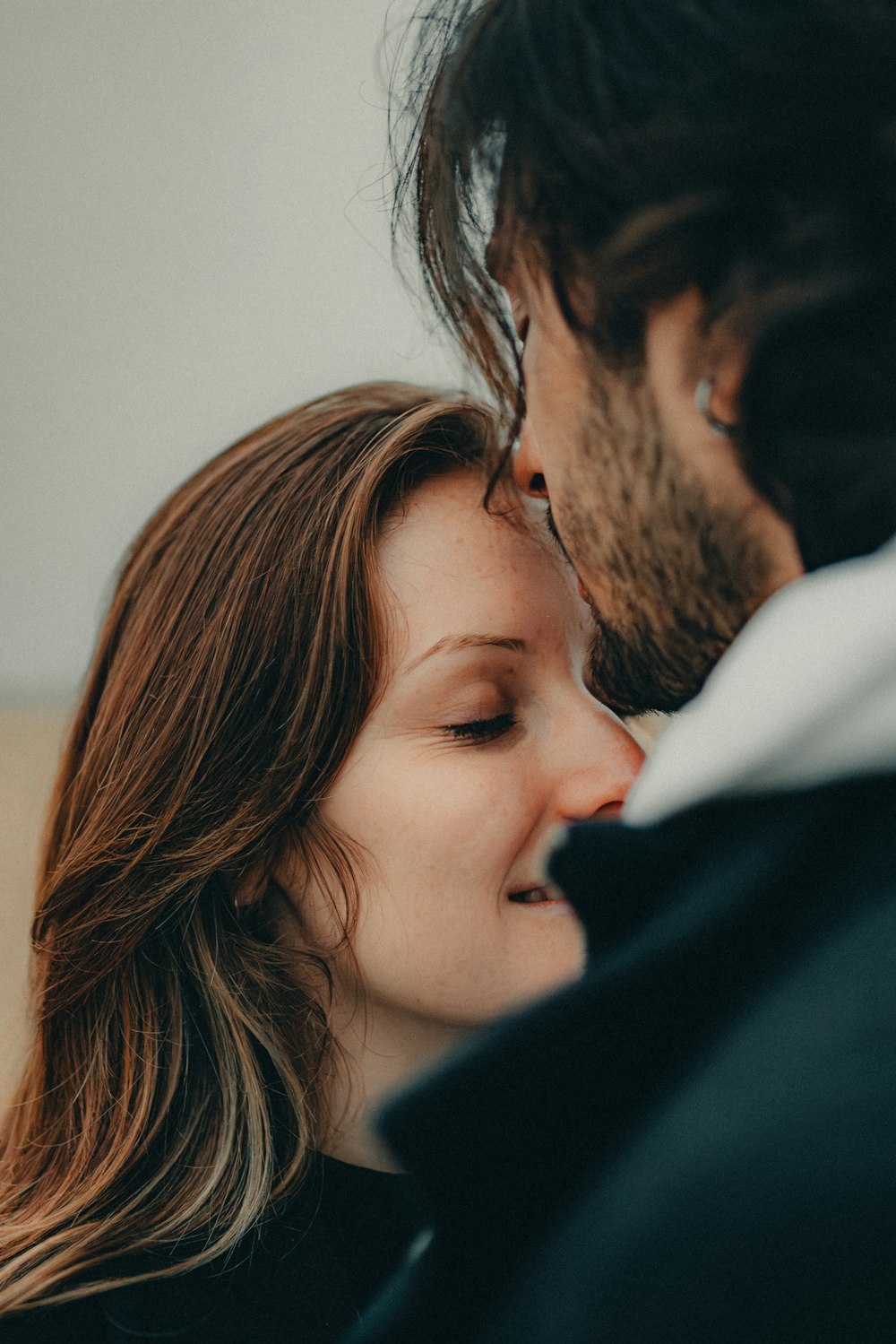 a man and a woman kissing each other