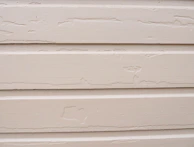 Close-up of a worker applying new siding panels on a home exterior near Linden Blvd.