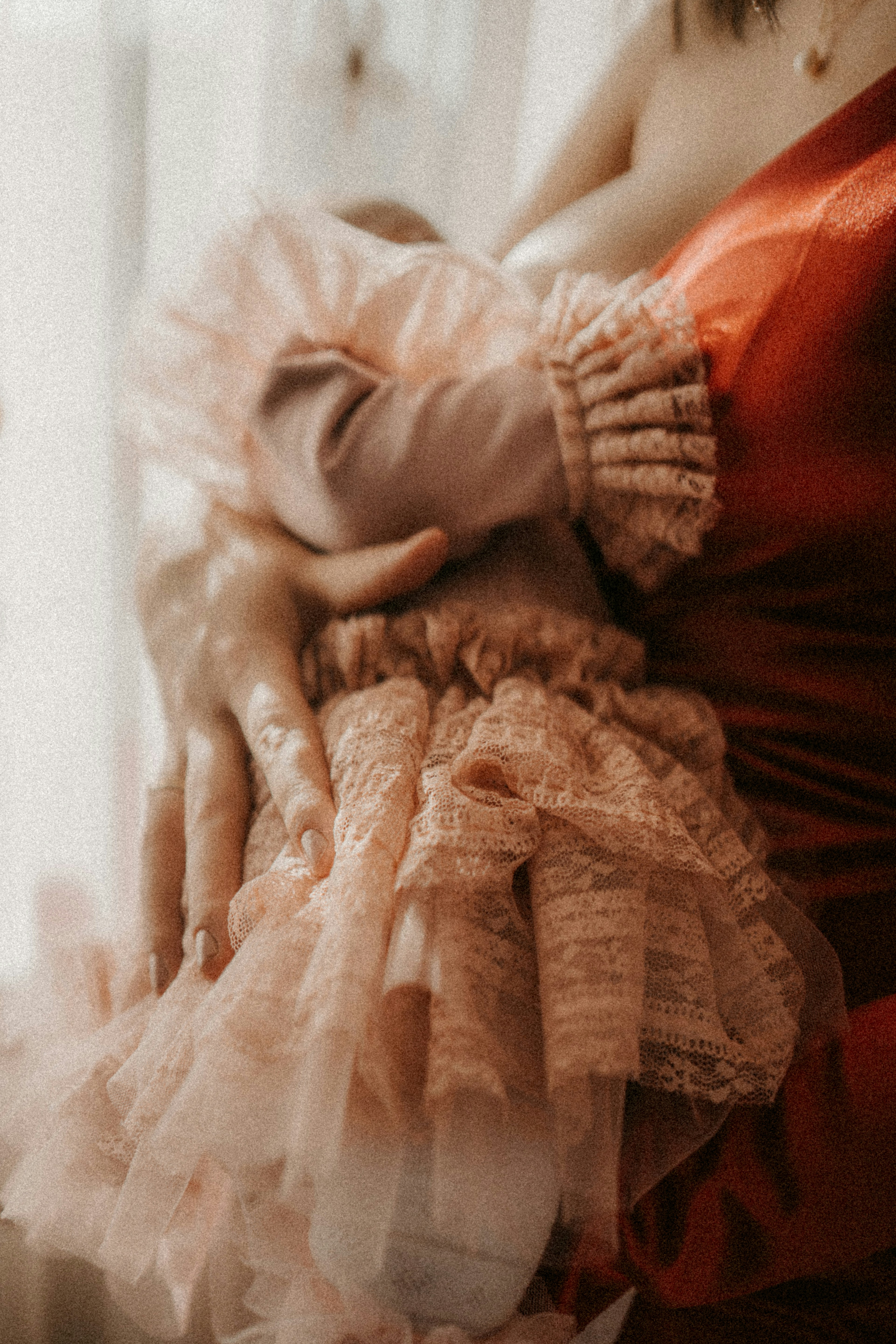 a woman in a red dress holding a baby