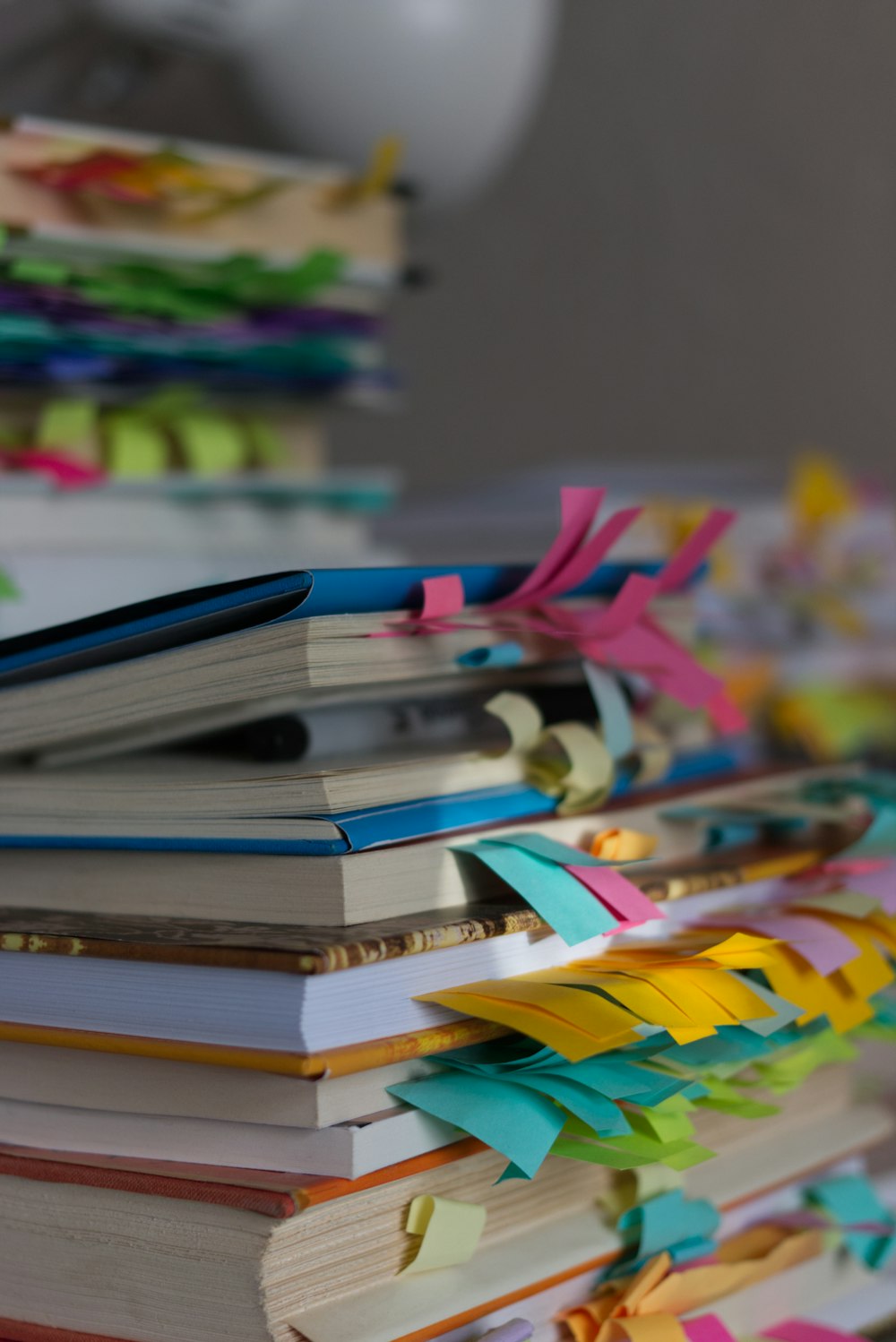 a stack of colorful books sitting on top of a table