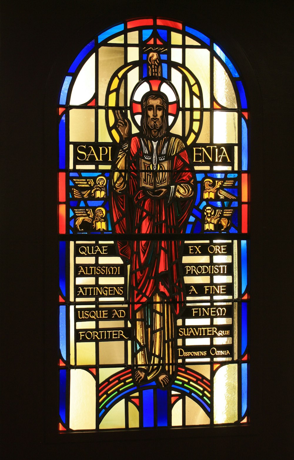 a stained glass window with a man holding a cross