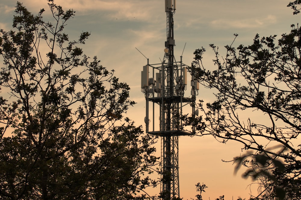 a very tall tower sitting between some trees