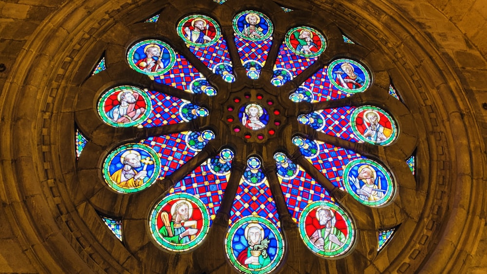 a large stained glass window inside of a church