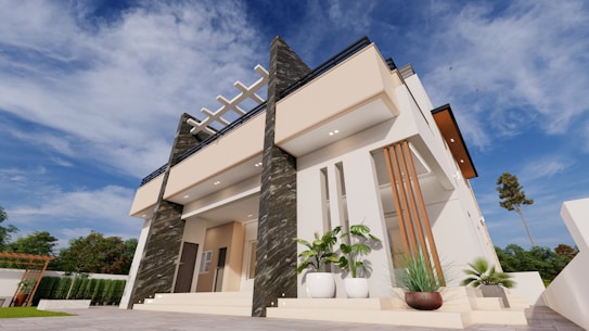 A modern two-story house with a flat roof, featuring a minimalist architectural style. The facade includes beige and dark textured panels, with large windows and a small terrace or balcony. Landscaping includes potted plants and surrounding greenery. The sky is bright and clear, suggesting a sunny day.