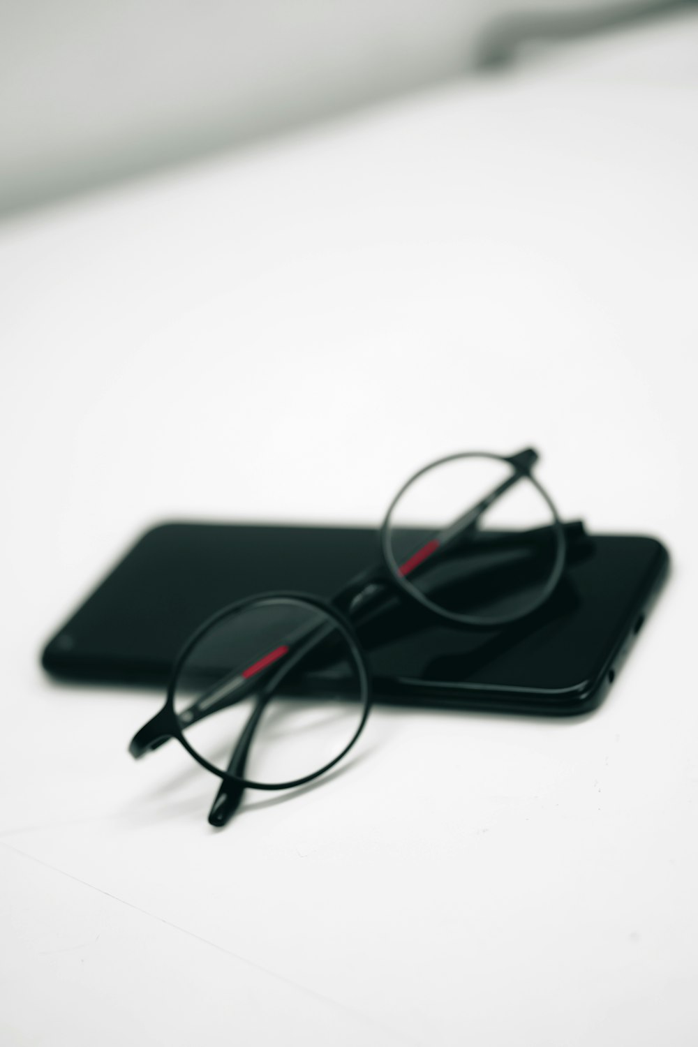 a pair of glasses sitting on top of a tablet