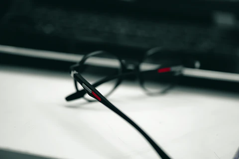 a pair of glasses sitting on top of a table