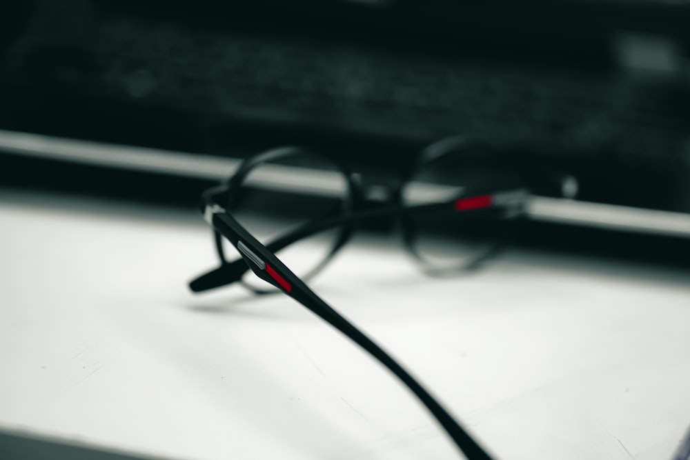 a pair of glasses sitting on top of a table