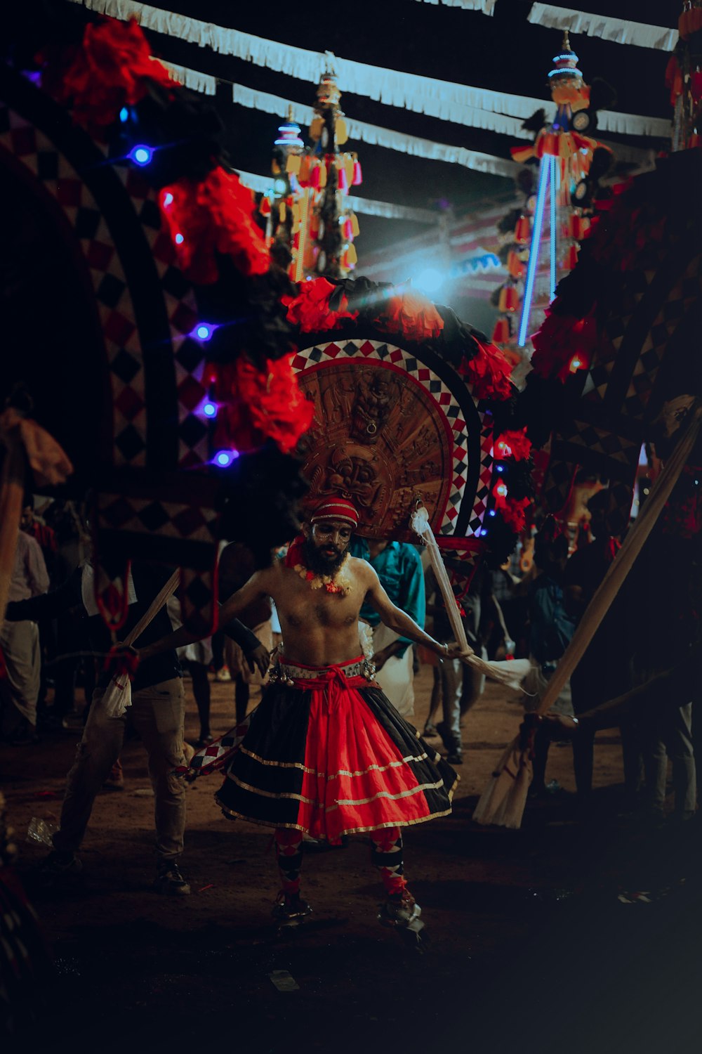 a man in a costume standing in front of a stage