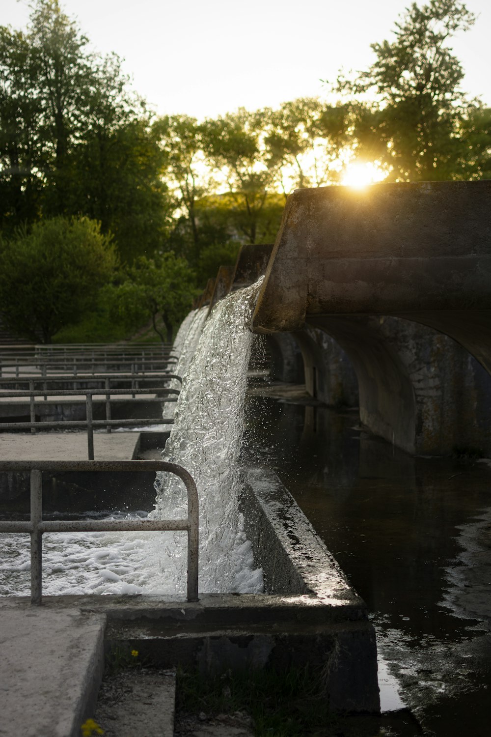 a water fall with a bridge in the background