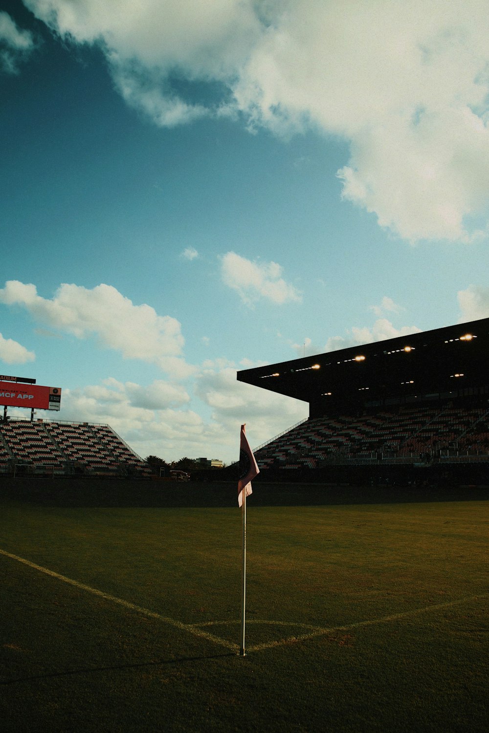 an empty soccer field with a flag on it