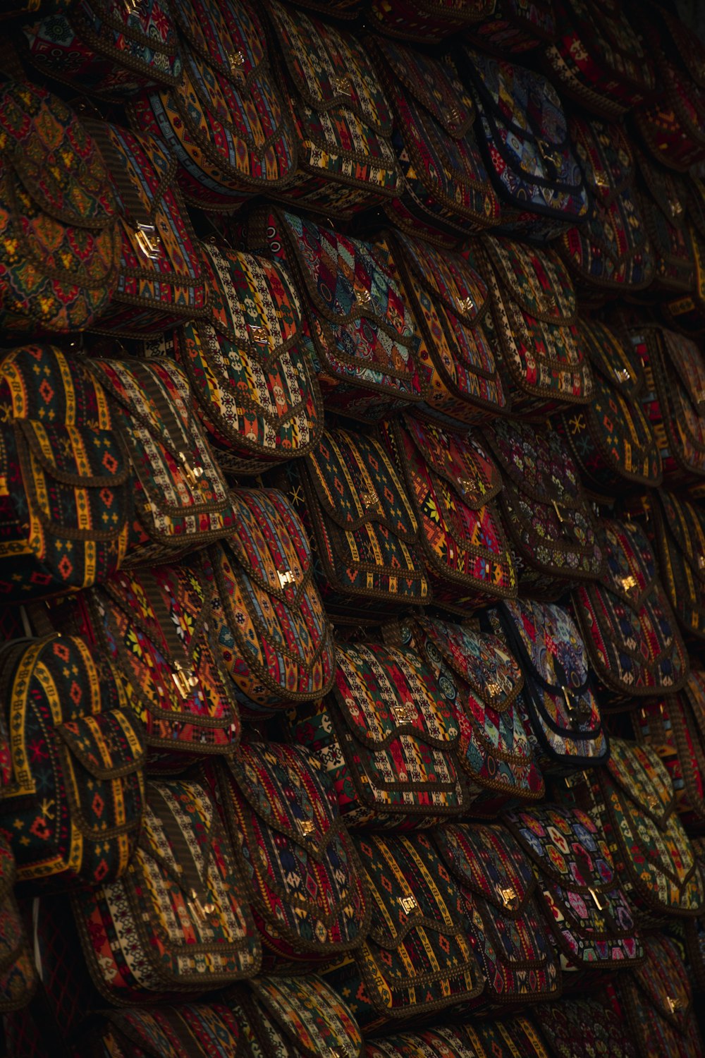 a pile of colorful rugs stacked on top of each other