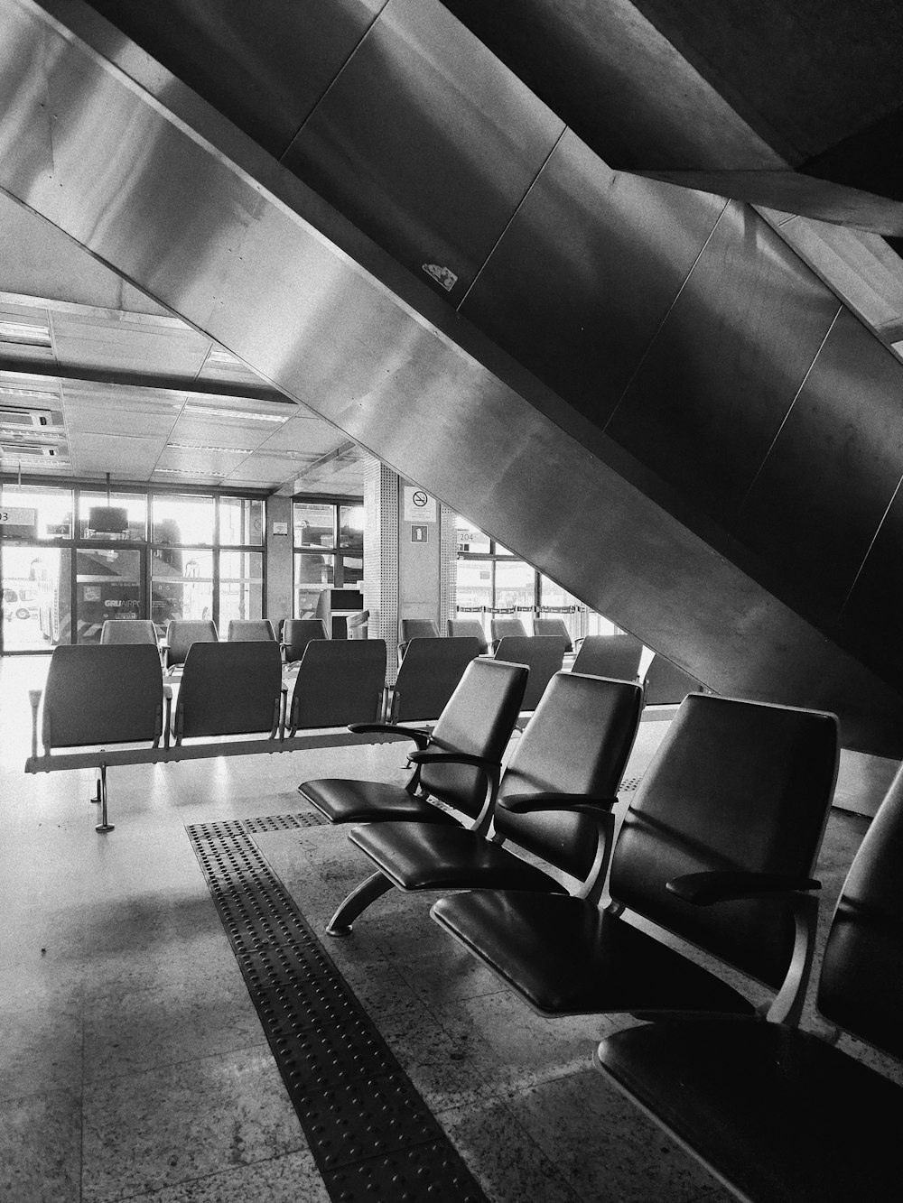 a black and white photo of a waiting area