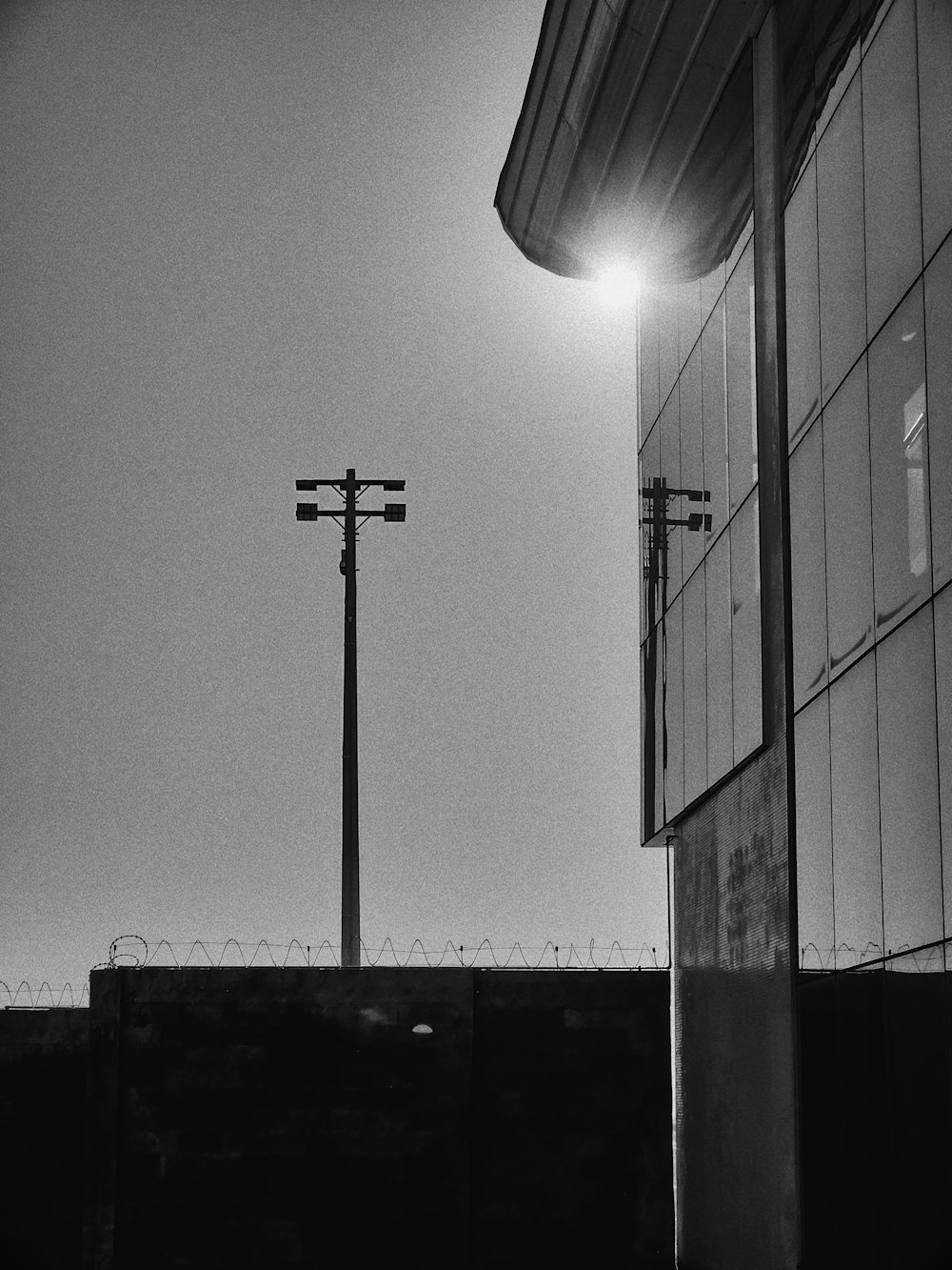 a black and white photo of a street light