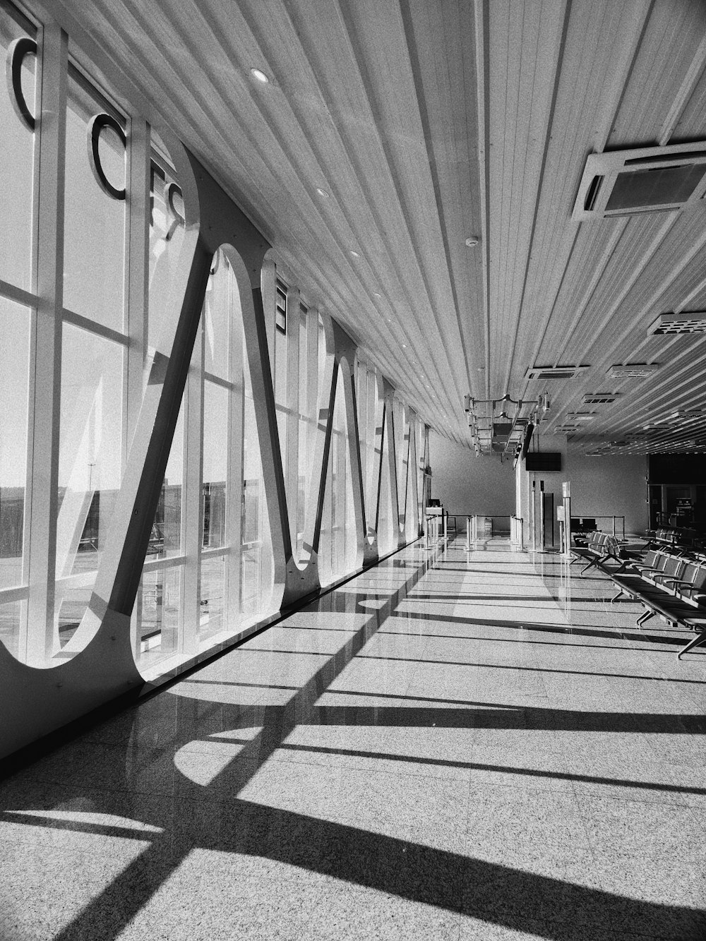 a black and white photo of a long hallway