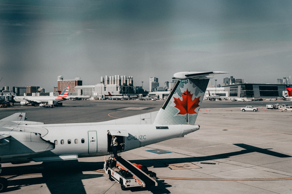 an airplane is parked on the tarmac at an airport