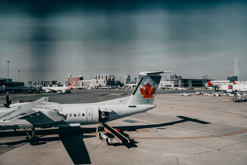 a canadian airplane parked on the tarmac at an airport