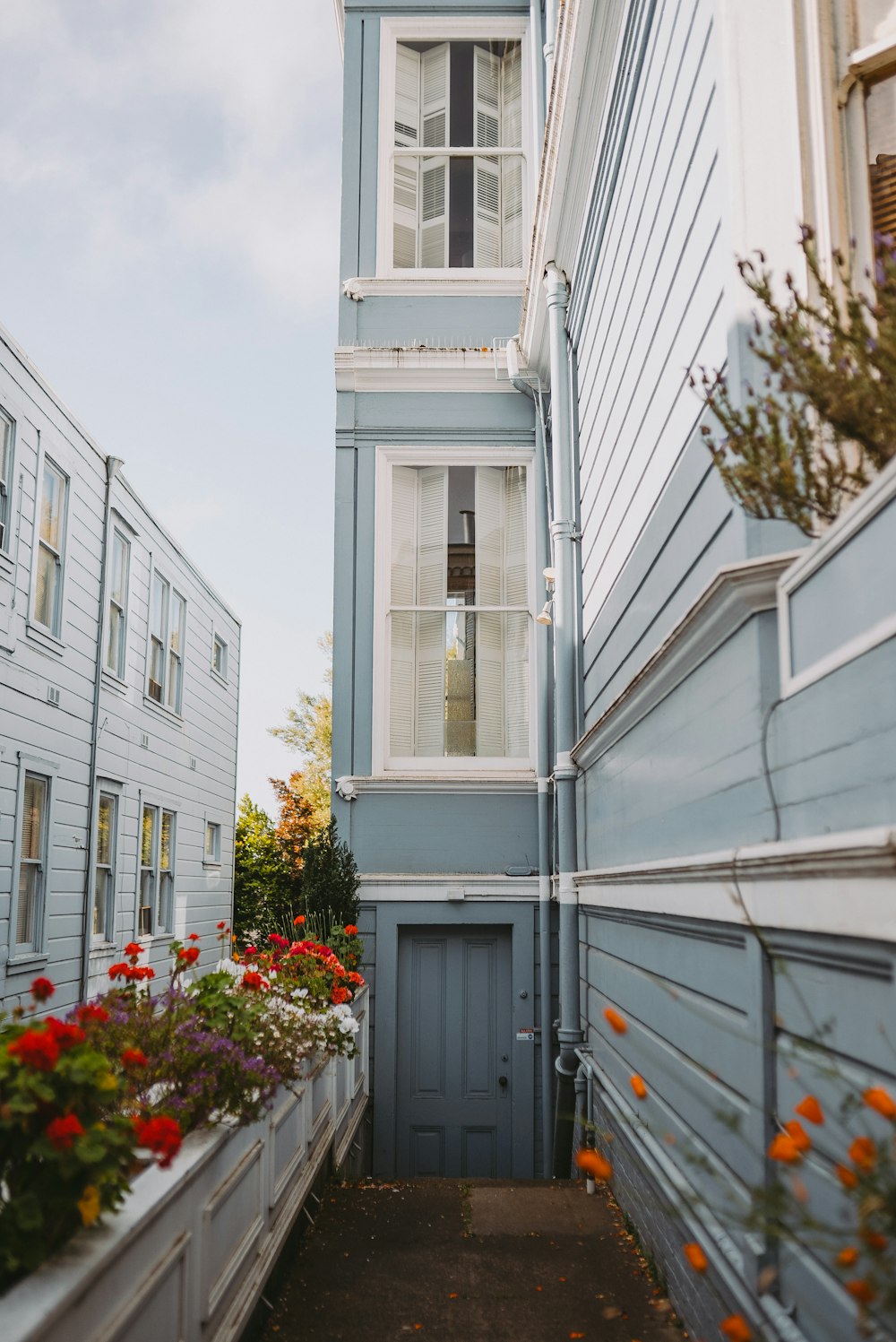 a blue building with a clock on the side of it