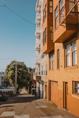 Sunlit street view highlighting multiple infill lots available for redevelopment.