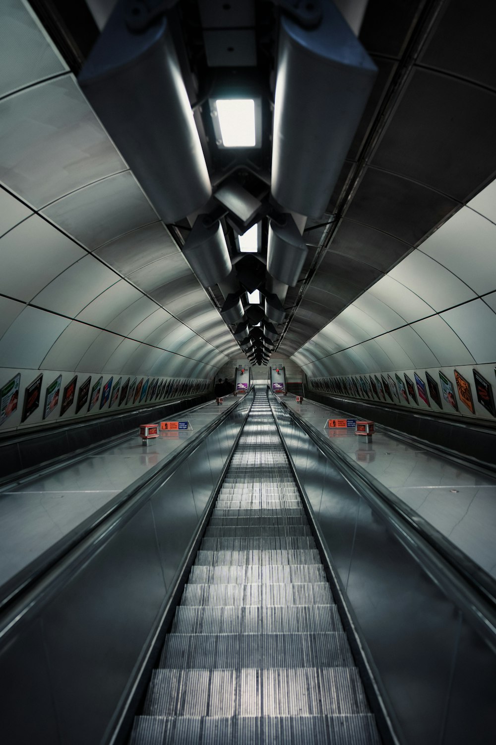 an empty subway station with a long escalator