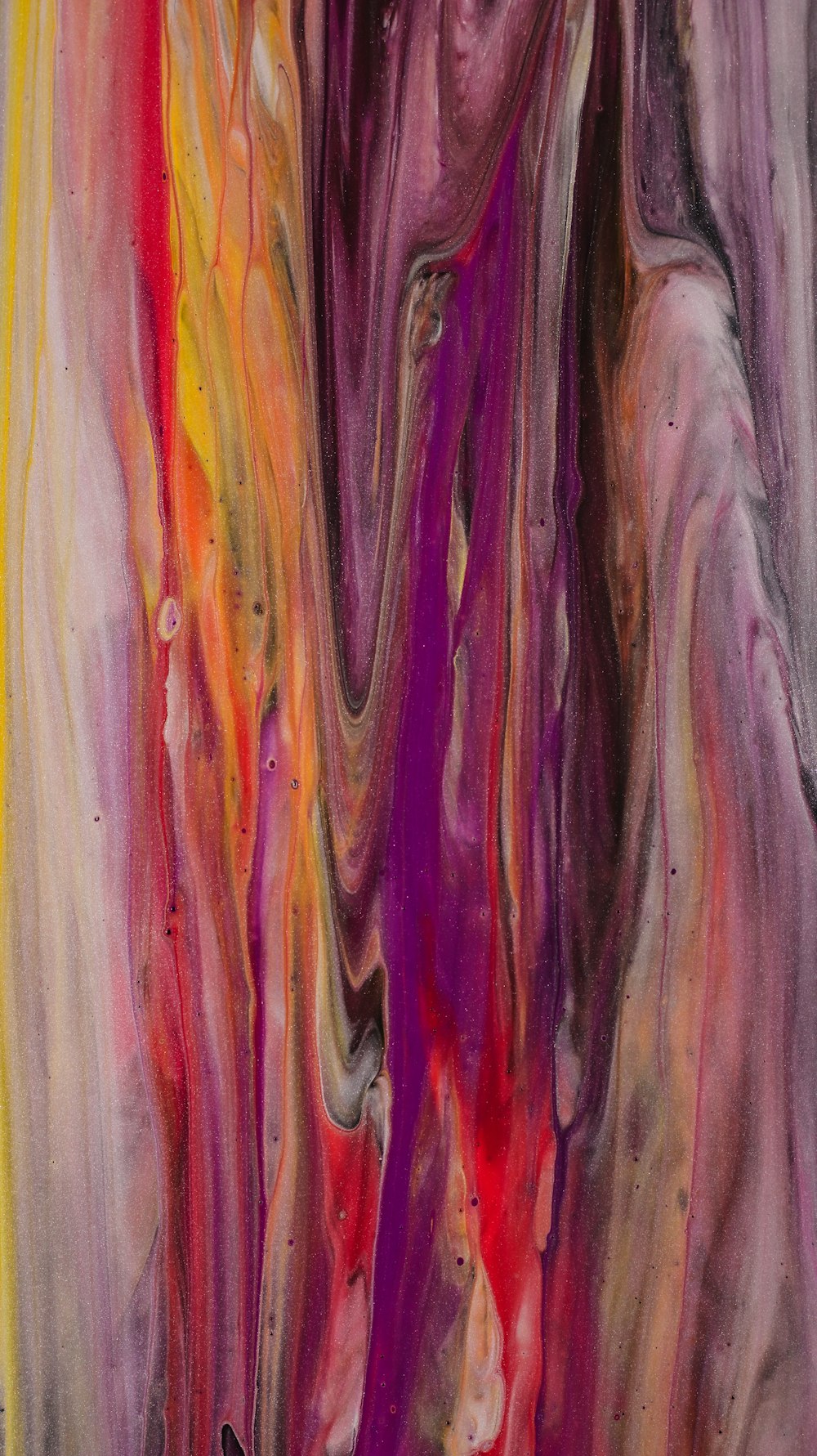 a painting of a purple, yellow, and red swirl