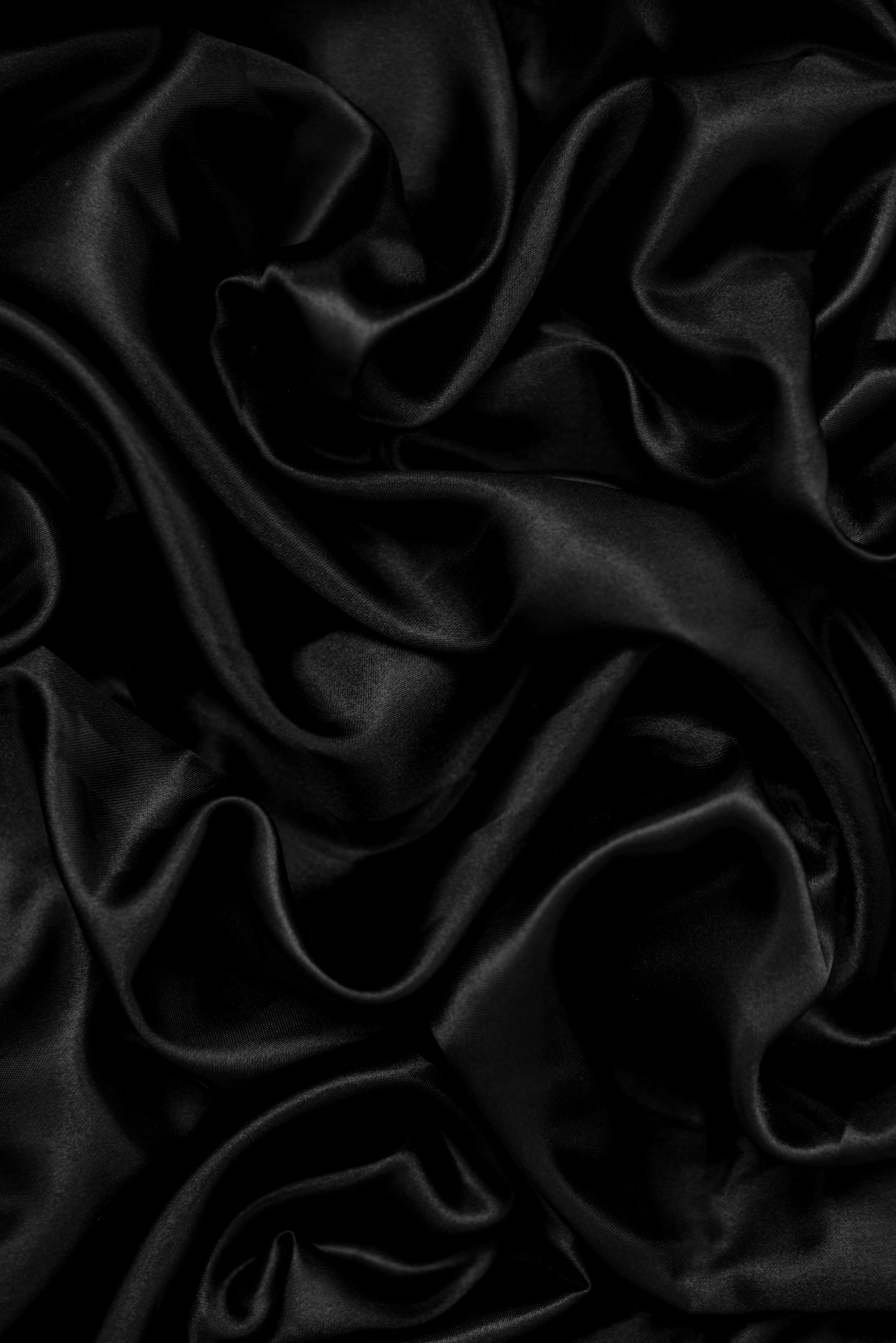a black background with a very large amount of fabric