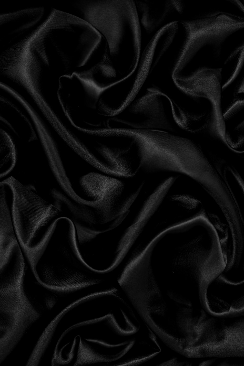 a black background with a very large amount of fabric