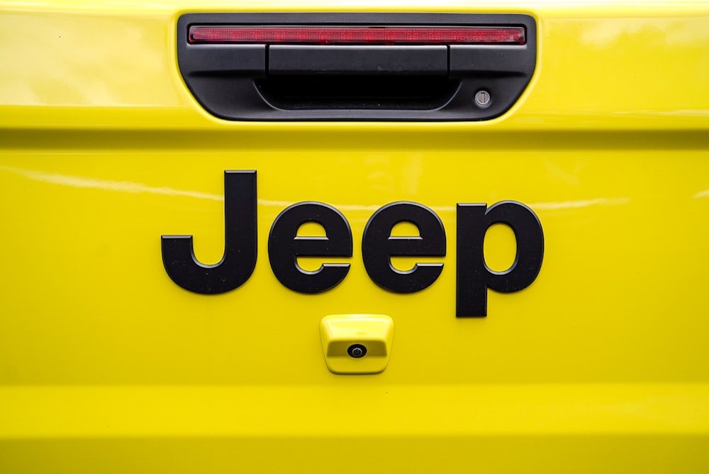 a yellow jeep with the word jeep on it