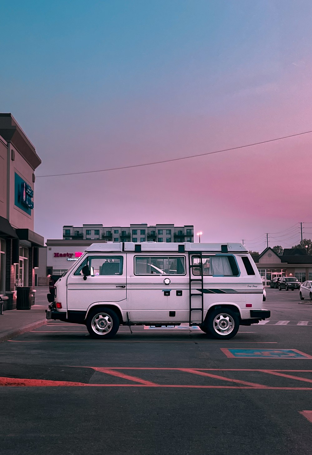 a white van is parked in a parking lot