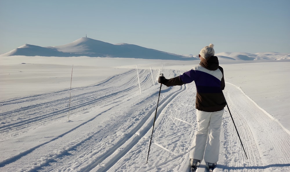 a person riding skis on a snowy surface