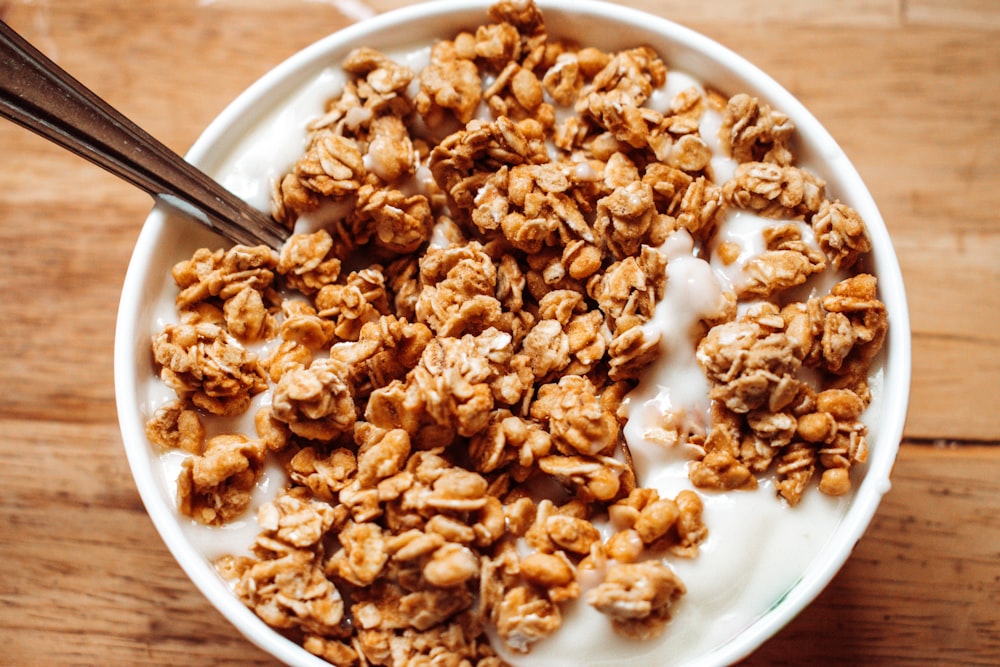 a bowl of granola on a wooden table