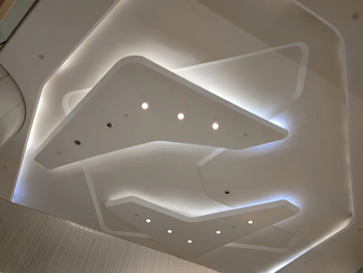 Modern false ceiling installation with integrated LED lighting in a sleek interior.