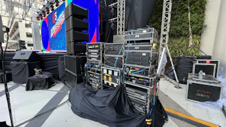 Stage setup featuring large speakers and microphones ready for a seminar in Agartala.