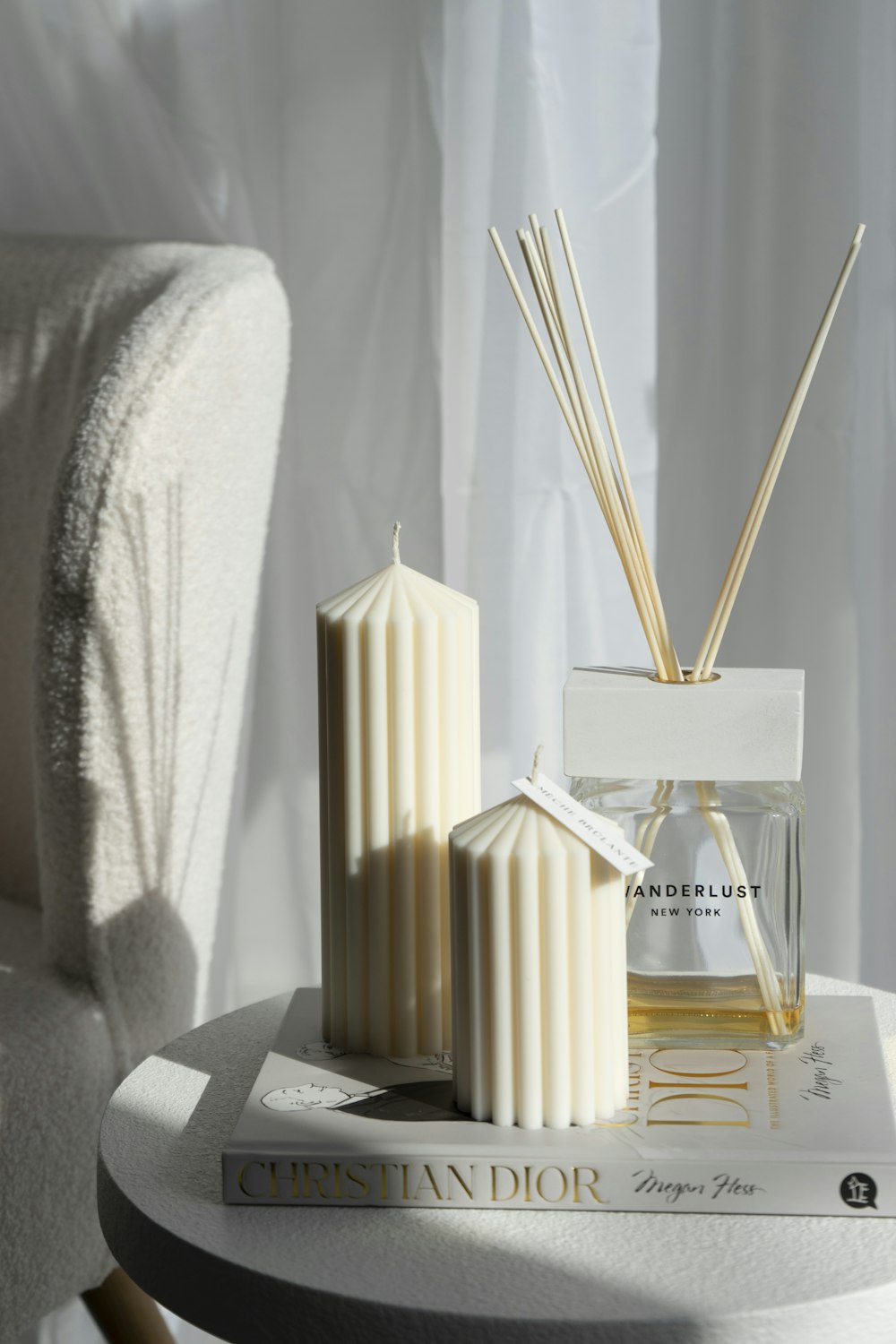 a white table with two candles and a book