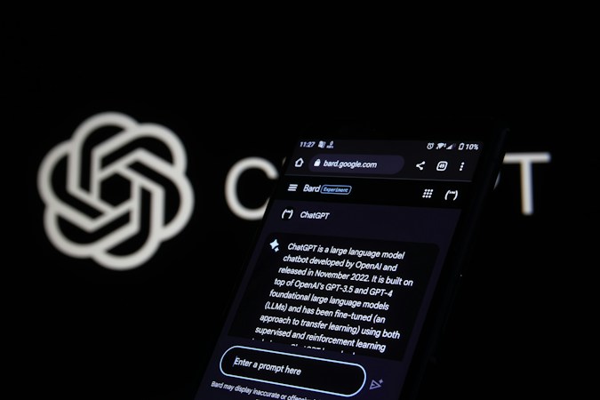A smartphone screen displays a web page about ChatGPT, featuring a black background with white text. The screen includes a search bar and various interface icons at the top. In the background, an OpenAI logo is partially visible against a black backdrop.