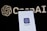 A smartphone screen displaying the ChatGPT logo in focus, with the OpenAI text and logo faintly visible in the background.