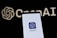 A smartphone screen displaying the ChatGPT logo in focus, with the OpenAI text and logo faintly visible in the background.