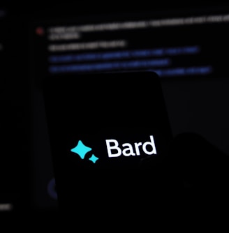 a person holding a cell phone with the word bard on it