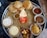 A vibrant plate of traditional Gujarati thali with various colorful dishes.