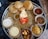 A vibrant plate of traditional Gujarati thali with various colorful dishes.