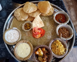 Close-up of a traditional Indian thali bursting with rich curries and rice.