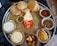 A close-up of a vibrant Maharashtrian thali with various dishes arranged neatly.