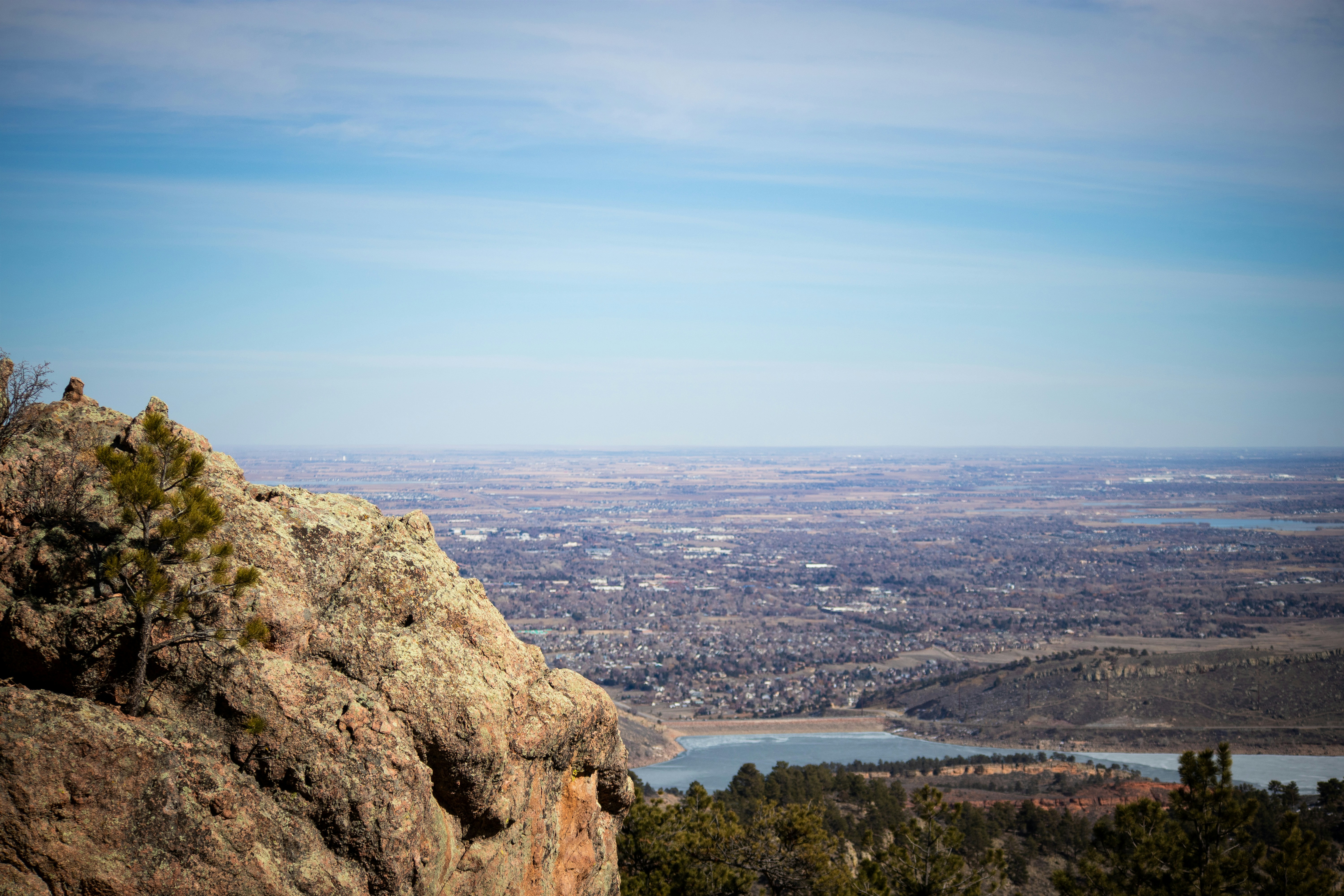 a view of a valley and a lake from the top of a mountain