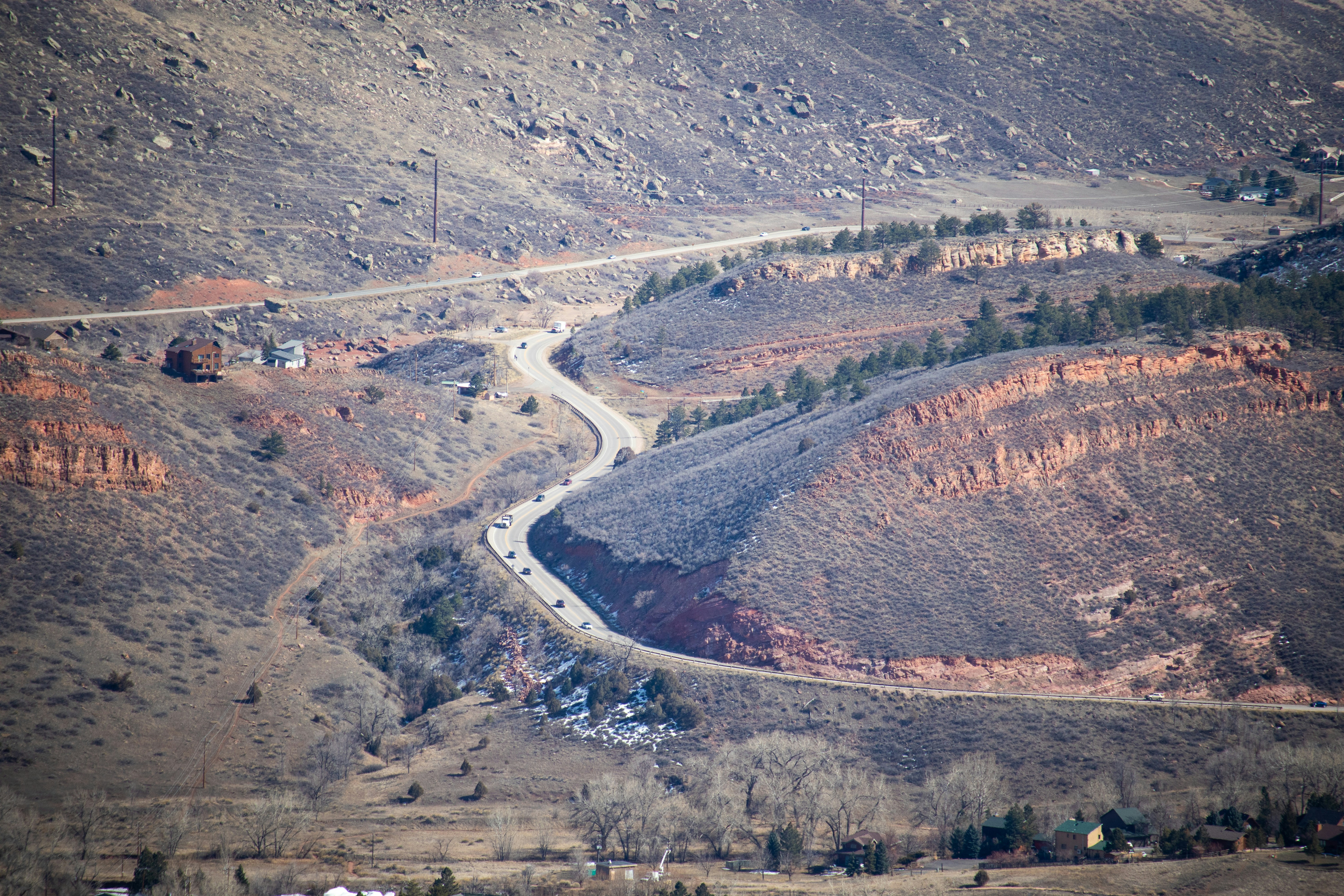 an aerial view of a winding road in the mountains